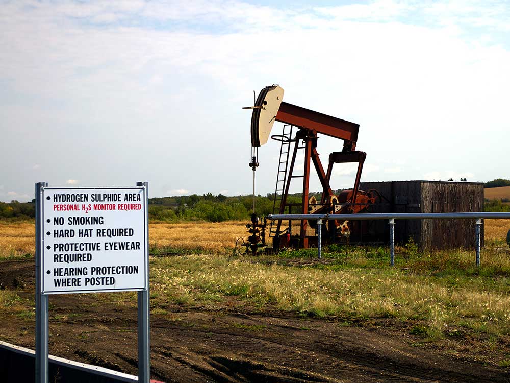 Oil pump with H2S warning sign