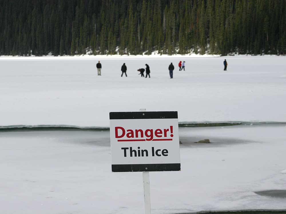 Sign on the shore of a lake says, "Danger! Thin Ice"